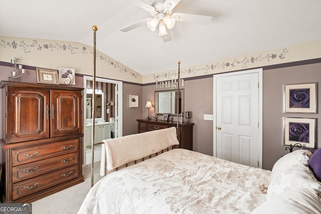 bedroom featuring ceiling fan, lofted ceiling, connected bathroom, and carpet