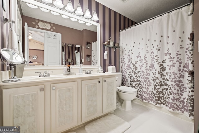 bathroom featuring a shower with shower curtain, a textured ceiling, vanity, and toilet