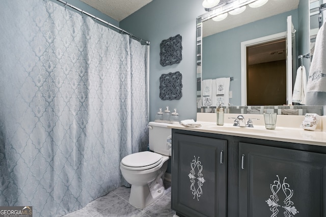 bathroom with tile patterned floors, a textured ceiling, vanity, and toilet