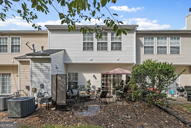 rear view of house with a patio area and central AC