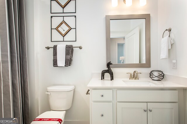 bathroom with vanity and toilet