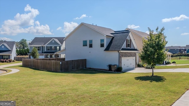 view of side of property featuring a garage and a yard