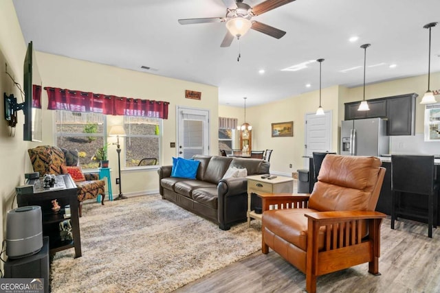 living room with ceiling fan and wood-type flooring