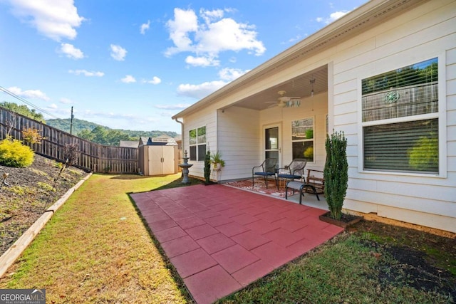 view of patio / terrace featuring ceiling fan and a shed