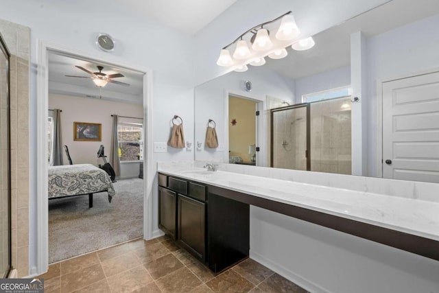 bathroom with ceiling fan, an enclosed shower, vanity, and a healthy amount of sunlight