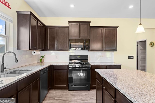 kitchen featuring black appliances, decorative backsplash, sink, decorative light fixtures, and dark brown cabinetry