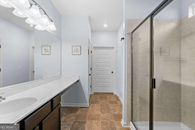 bathroom with a shower with door and vanity