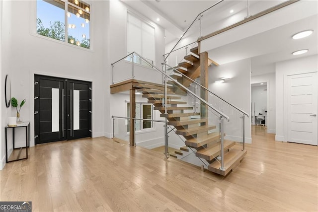 foyer entrance featuring a high ceiling and hardwood / wood-style flooring