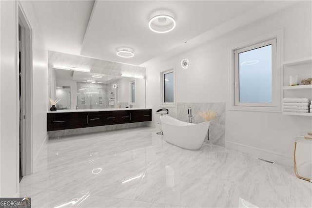 bathroom featuring vanity and a washtub