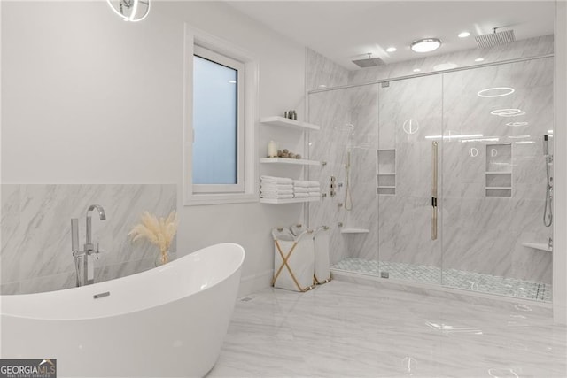 bathroom featuring shower with separate bathtub