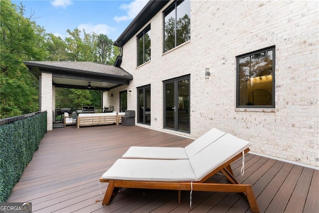 deck featuring outdoor lounge area and ceiling fan