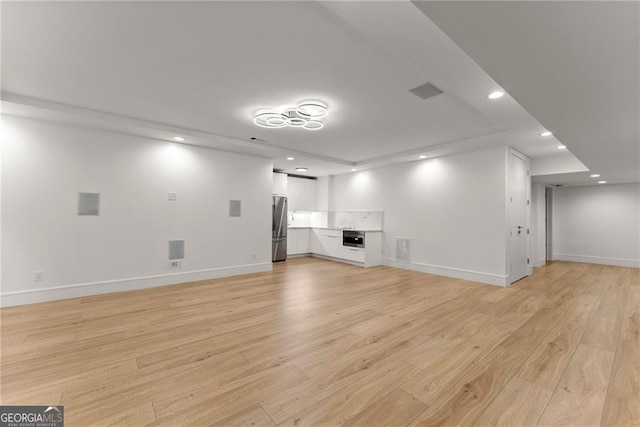 interior space with stainless steel refrigerator and light wood-type flooring