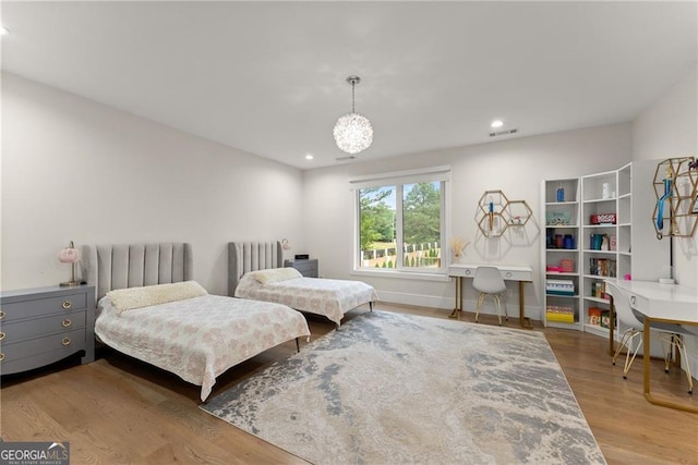 bedroom with radiator and hardwood / wood-style floors