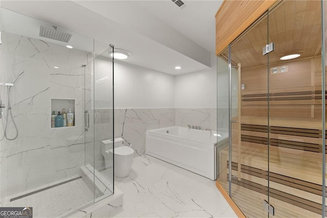 bathroom featuring tile walls and separate shower and tub