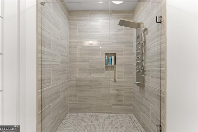 bathroom with a shower with door