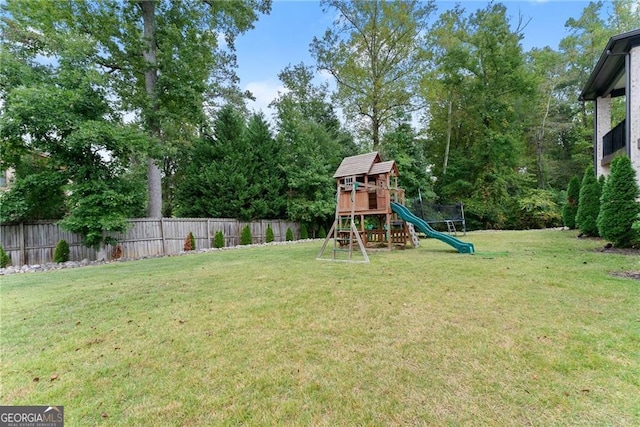 view of playground with a lawn