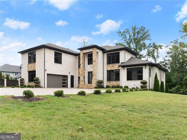 view of front of home with a front yard and a garage