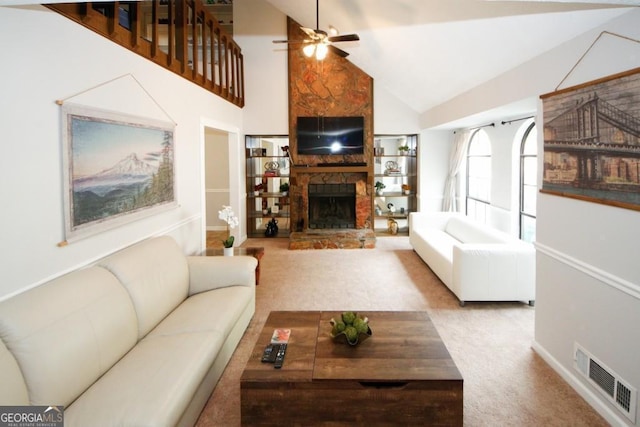 carpeted living area with baseboards, a fireplace, a ceiling fan, visible vents, and high vaulted ceiling