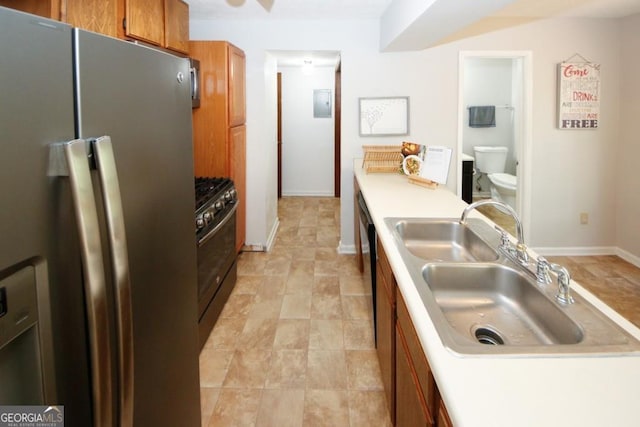 kitchen featuring stainless steel appliances, electric panel, and sink