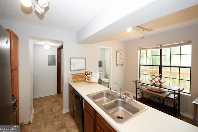 kitchen with rail lighting, black dishwasher, electric panel, and sink