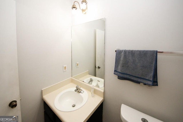 bathroom featuring vanity and toilet