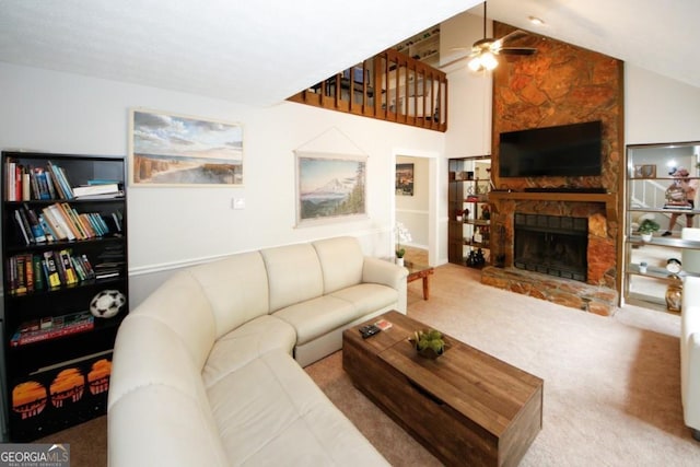 carpeted living room featuring ceiling fan, lofted ceiling, and a fireplace