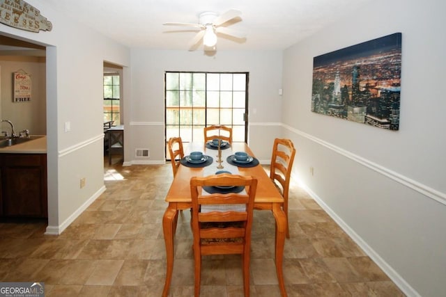 dining space with sink and ceiling fan