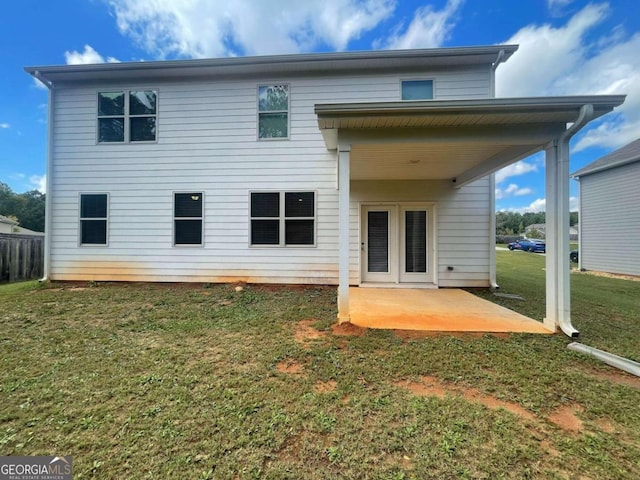 rear view of property with a yard and a patio