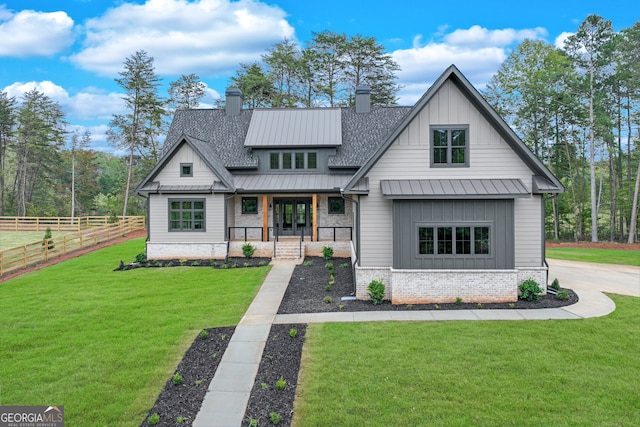 modern farmhouse featuring a porch and a front yard