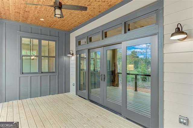 doorway featuring hardwood / wood-style floors, ceiling fan, and wooden ceiling