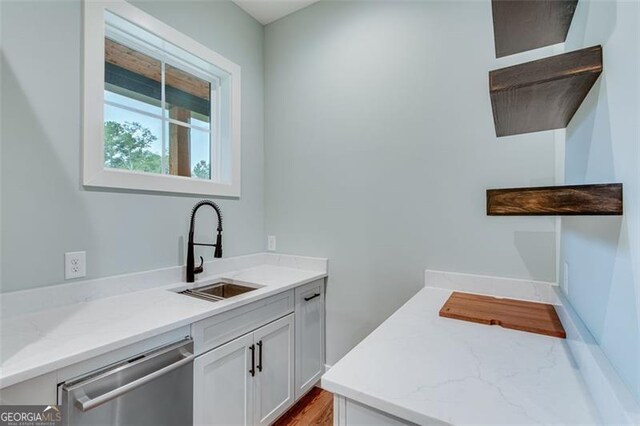 clothes washing area with sink