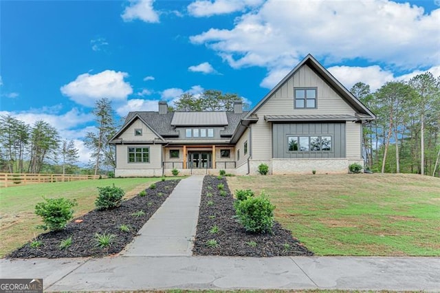 view of front of home with covered porch and a front yard