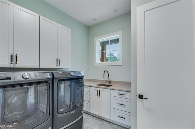 washroom with cabinets, light tile patterned floors, sink, and independent washer and dryer