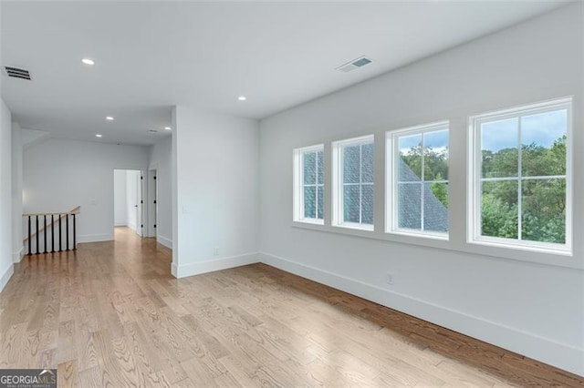 spare room with light hardwood / wood-style flooring