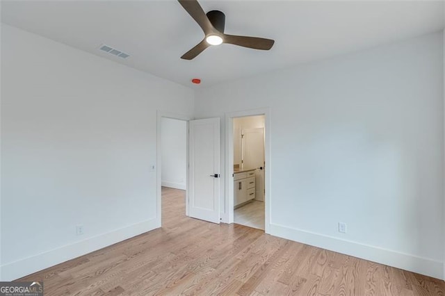 unfurnished bedroom with ceiling fan, light hardwood / wood-style flooring, and ensuite bathroom