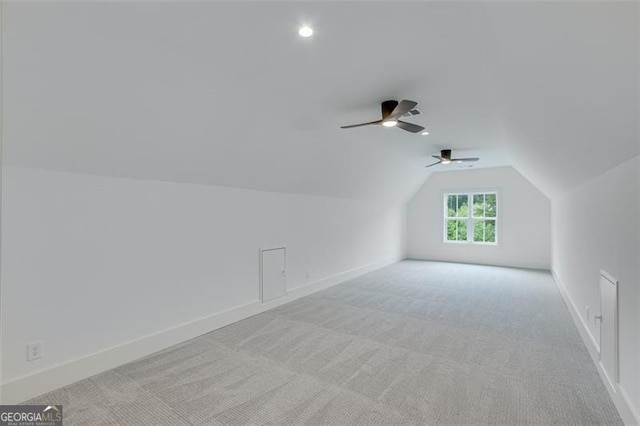 bonus room with light colored carpet and lofted ceiling