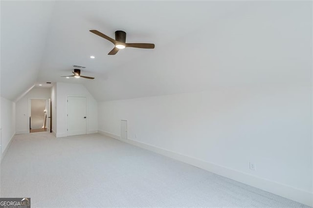 bonus room featuring vaulted ceiling and light colored carpet