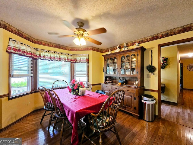 dining space with a textured ceiling, dark hardwood / wood-style flooring, and ceiling fan