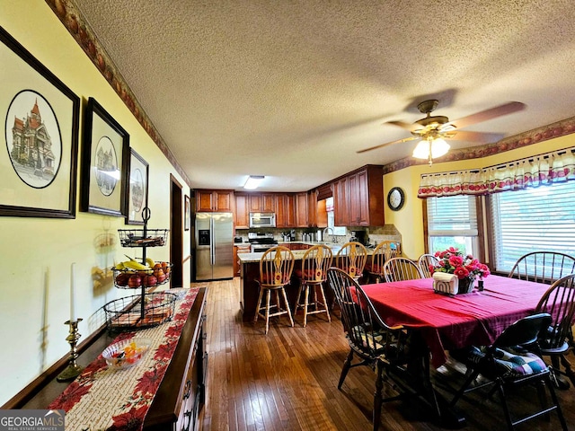 dining space with a textured ceiling, dark hardwood / wood-style flooring, ceiling fan, and sink