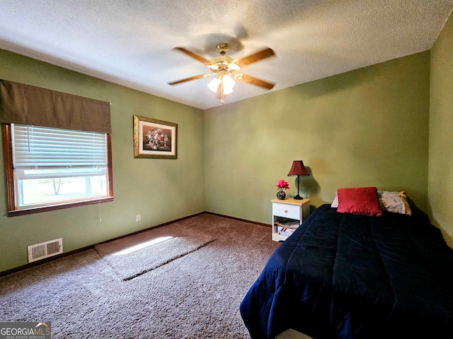 bedroom featuring a textured ceiling, carpet, and ceiling fan