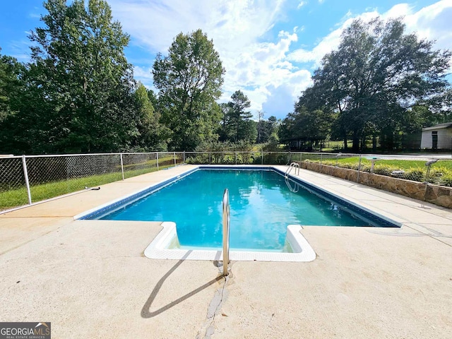 view of swimming pool featuring a patio area