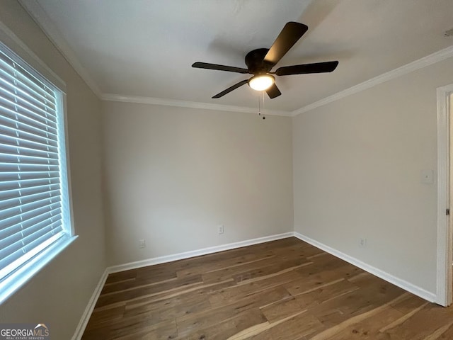 empty room with ceiling fan, crown molding, and dark hardwood / wood-style flooring