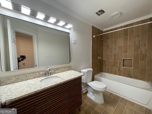 full bathroom with tiled shower / bath, vanity, crown molding, and toilet