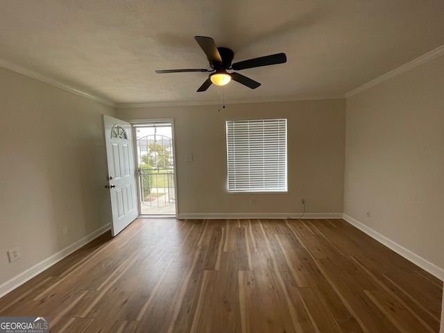 empty room with a textured ceiling, crown molding, dark hardwood / wood-style flooring, and ceiling fan