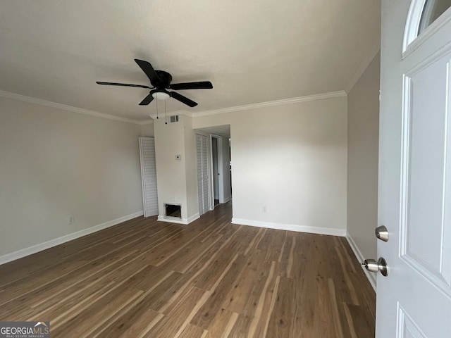 empty room featuring ceiling fan, dark hardwood / wood-style floors, and ornamental molding