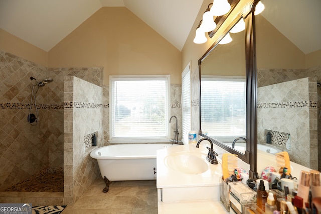 bathroom featuring shower with separate bathtub, tile patterned flooring, tile walls, lofted ceiling, and vanity