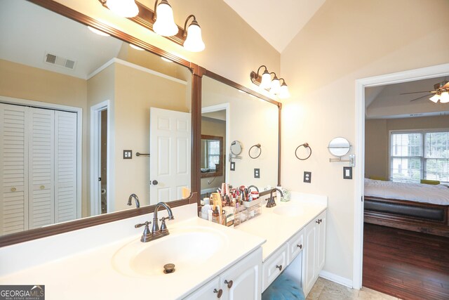 bathroom with wood-type flooring, lofted ceiling, crown molding, ceiling fan, and vanity