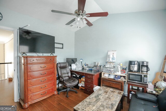 office space featuring vaulted ceiling, ceiling fan, and dark wood-type flooring