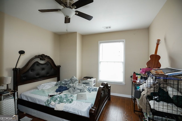 bedroom with ceiling fan and dark hardwood / wood-style floors