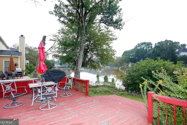 wooden deck featuring a water view